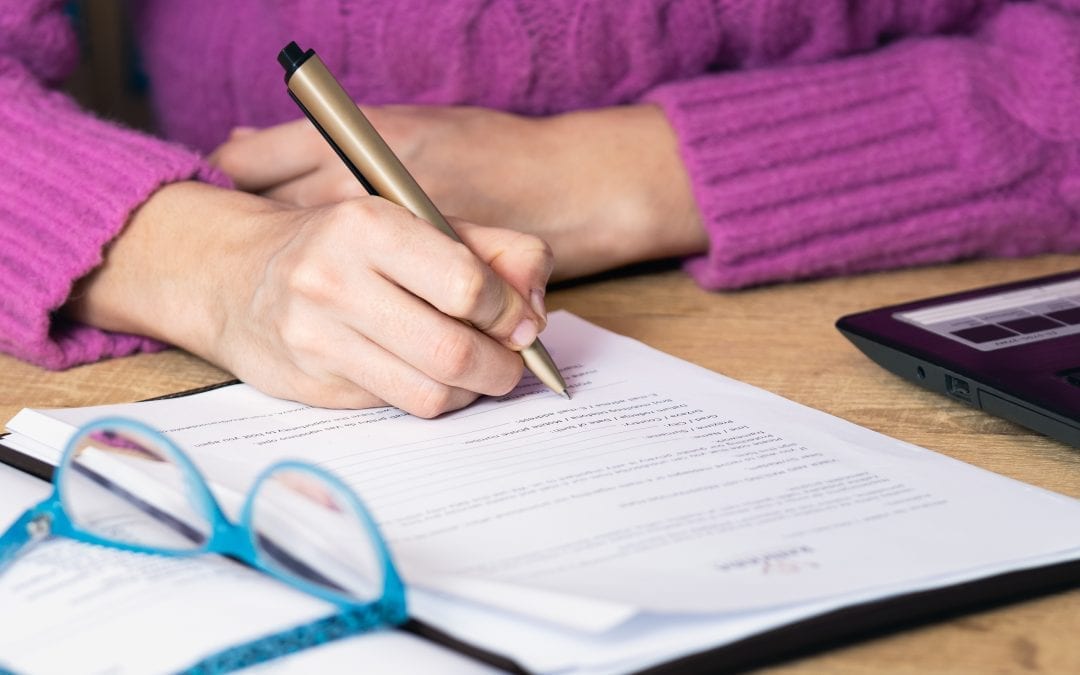 Businesswoman signing document.