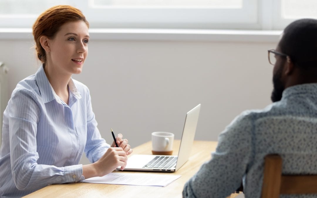Female businesswoman having good impression from interviewing black job candidate