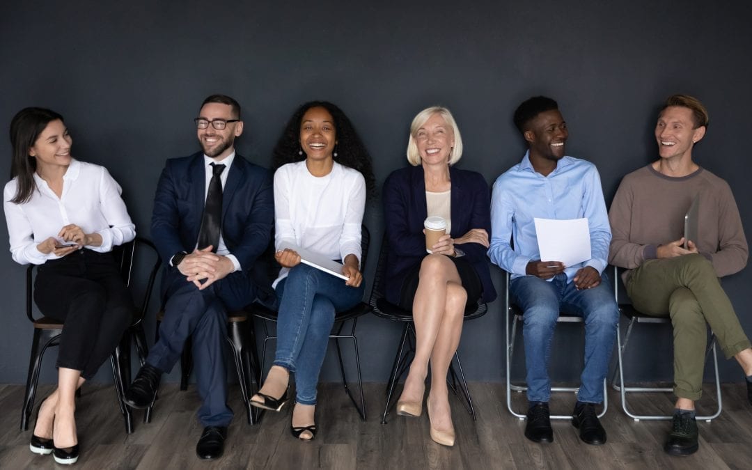 Happy Multiracial Businesspeople Group Sit On Chairs Laughing